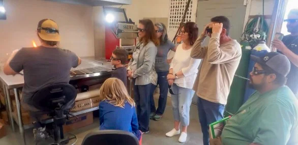 Students at the torch during a glass class at Passage Gallery